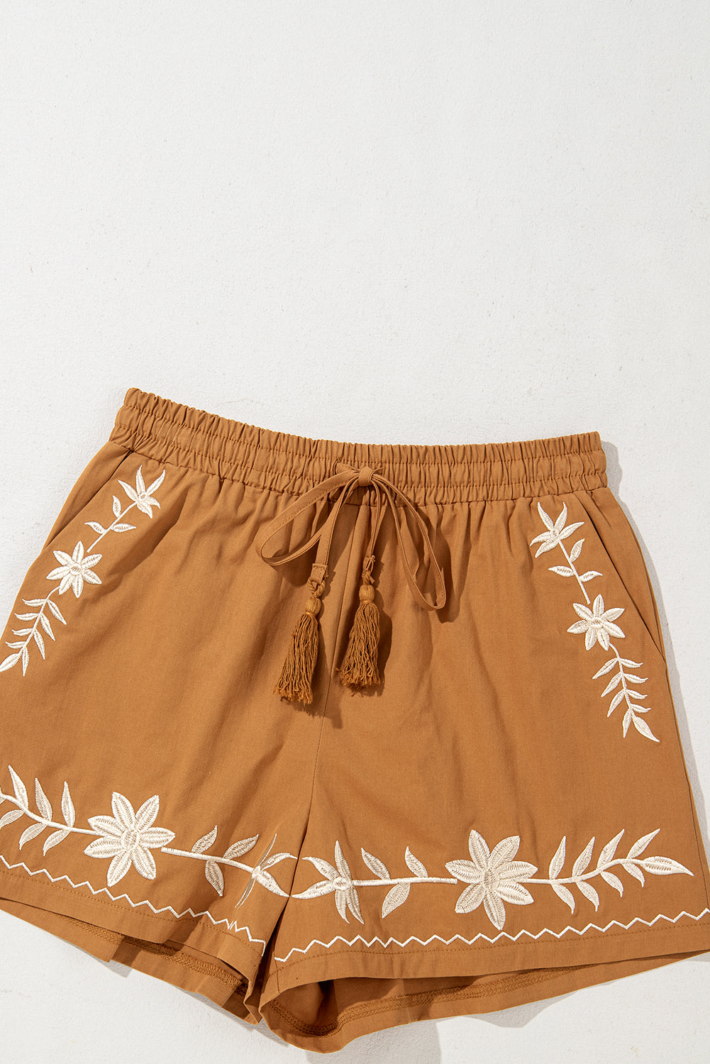LuckeLAdybug LLC embroidered shorts in brown with white floral design and adjustable tassel tie