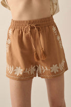 LuckeLAdybug LLC embroidered shorts in tan with floral design and tassel drawstring