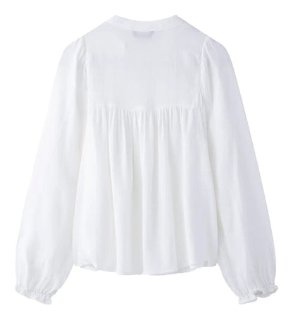 Back view of an embroidered white blouse for women with long puff sleeves from LuckeLadybug LLC