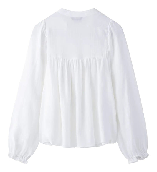 Back view of an embroidered white blouse for women with long puff sleeves from LuckeLadybug LLC