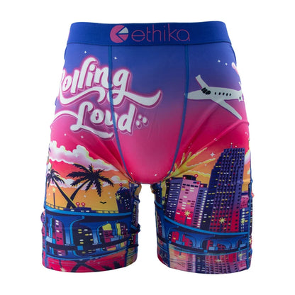 Ethika men's boxer briefs featuring a vibrant beach sunset design with city skyline and airplane