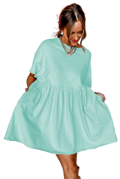 LuckeLadybug sky blue babydoll dress on model with short sleeves gathered waist mini length