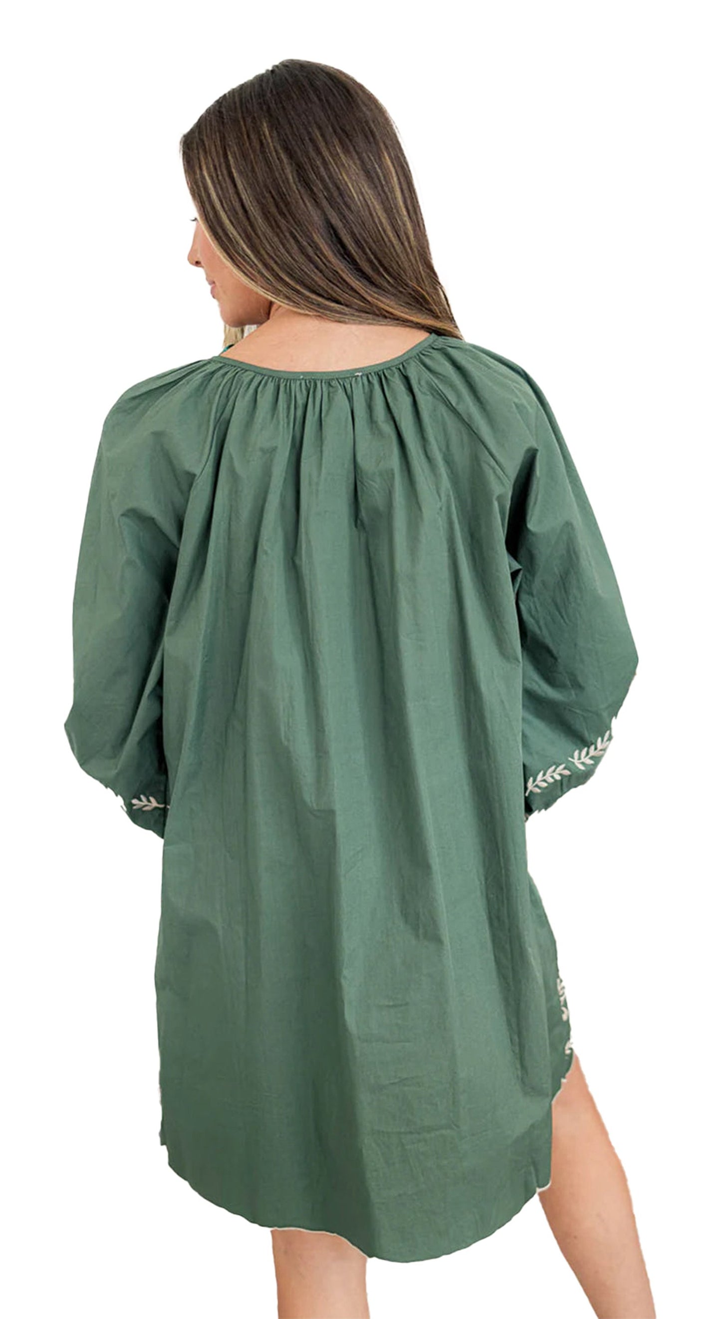 Back view of model wearing mist green boho floral dress loose mini length long sleeves embroidered cuffs