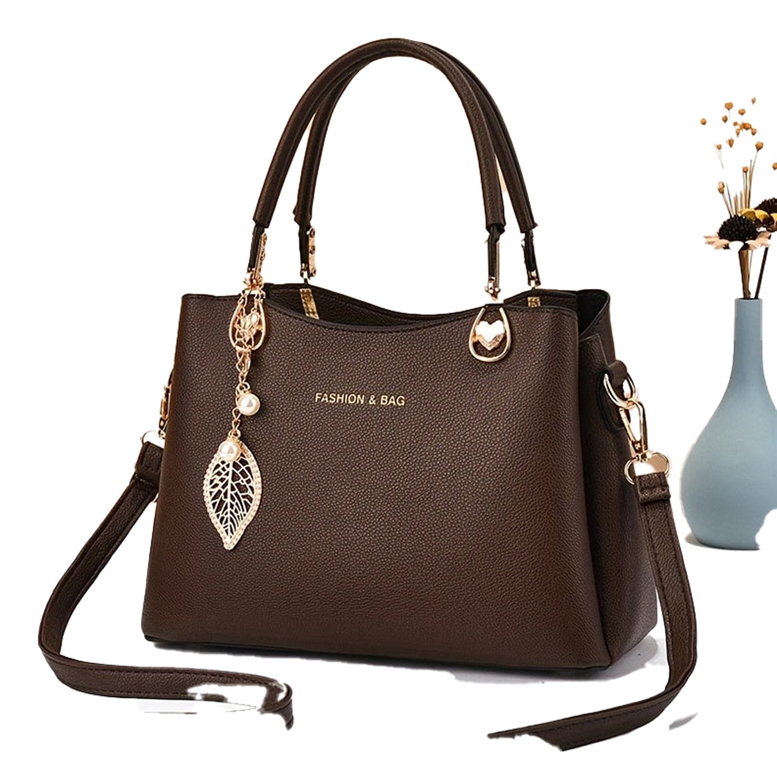 Elegant white handbag for women by LuckeLadybug LLC designed with a stylish leaf charm and adjustable strap