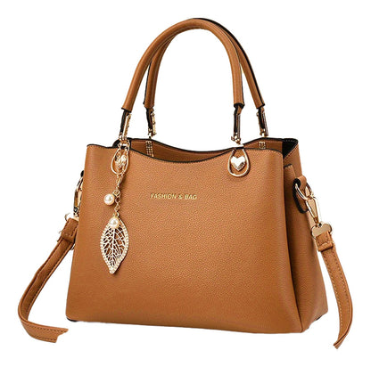 Stylish tan satchel from LuckeLadybug LLC, perfect for pairing with outfits, featuring a detachable strap.
