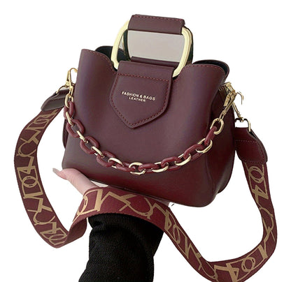 LuckeLadybug fashion top handle bucket bag in burgundy with a chain strap and modern design