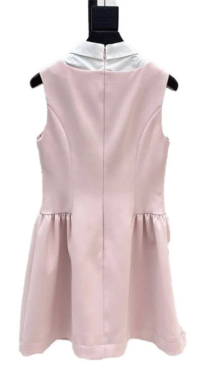 Back view of a pink waist cinching mini dress for women with a white collar and pleated skirt