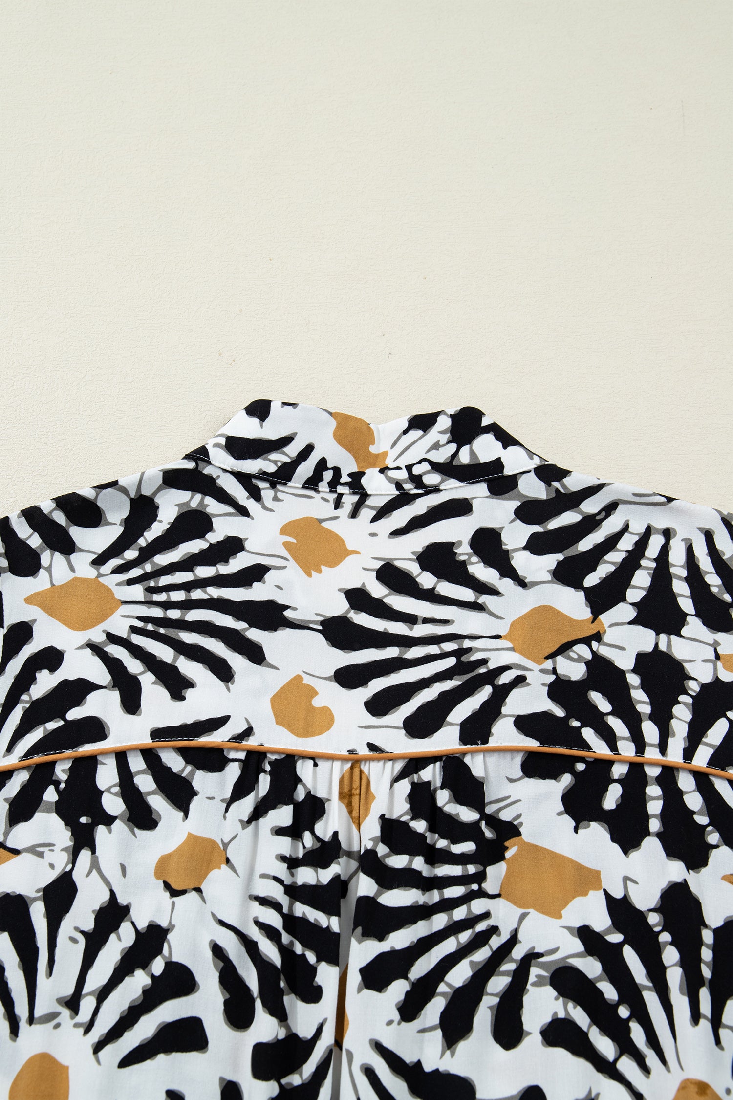 Back view of a floral dress dress with a unique black and gold print, perfect for any occasion