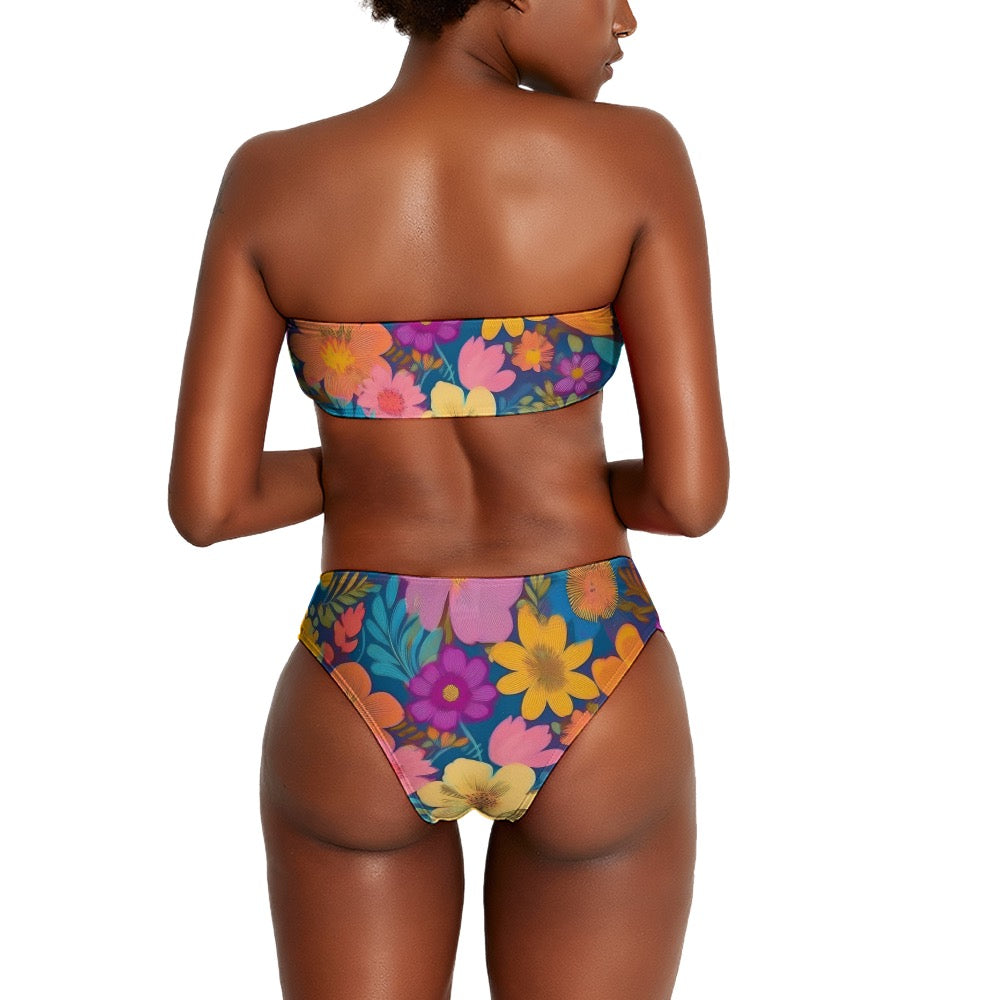 Back view of a model wearing a colorful floral two piece bikini with vibrant flower patterns