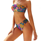 floral two piece bikini with colorful yellow and purple flowers worn by model by pool