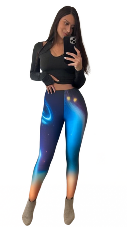 Woman wearing luckeladybug galaxy print leggings with a vibrant blue and orange space design