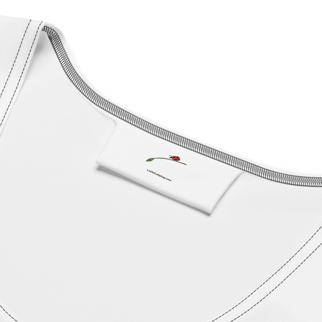 Close-up of LuckeLadybug white beach bodycon dress neckline with brand label and stitching details