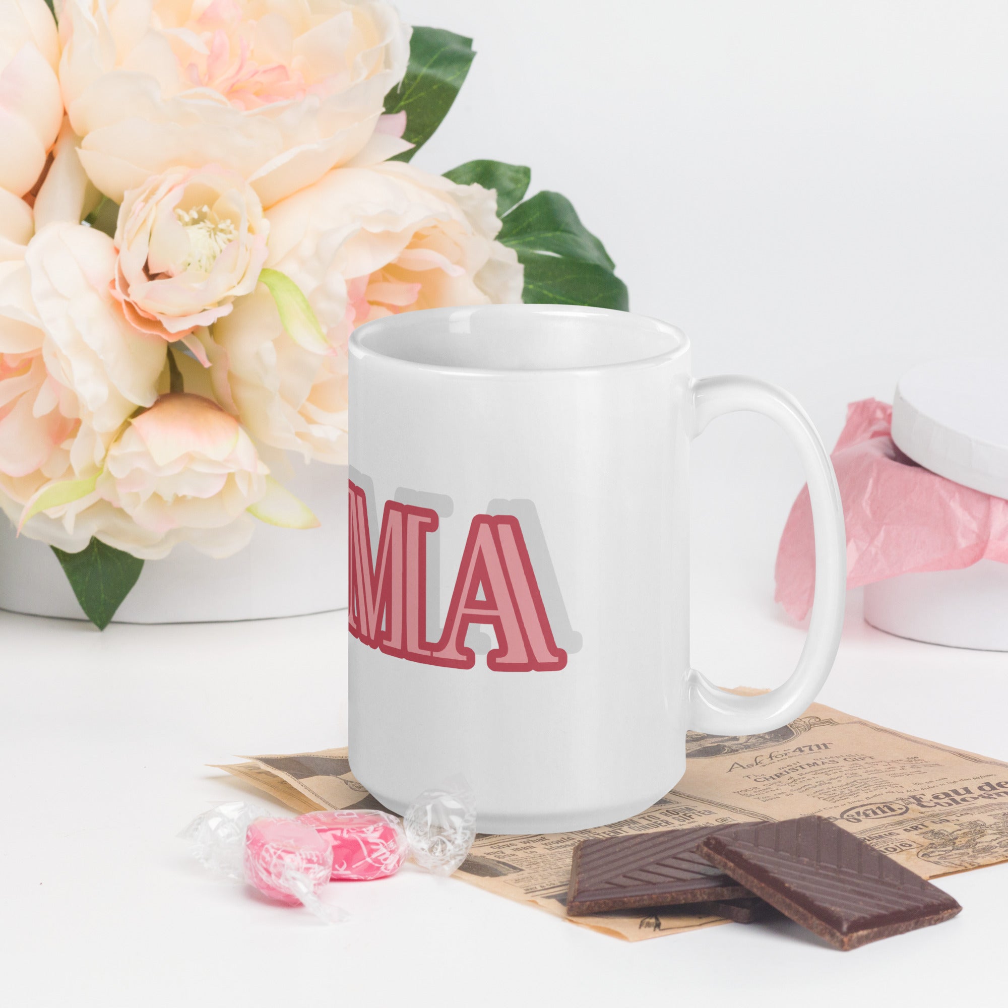 LuckeLadybug glam ma coffee mug with pink typography displayed with flowers and chocolates