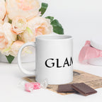 White ceramic glam ma coffee mug with black text surrounded by flowers and chocolates