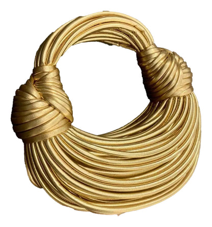 Gold designer handwoven handbag with an elegant, twisted handle for stylish outings