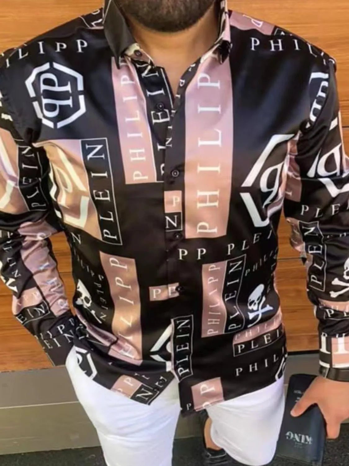 Stylish black button-up shirt with graphic prints for a trendy look, perfect as a graphic men's t shirt.