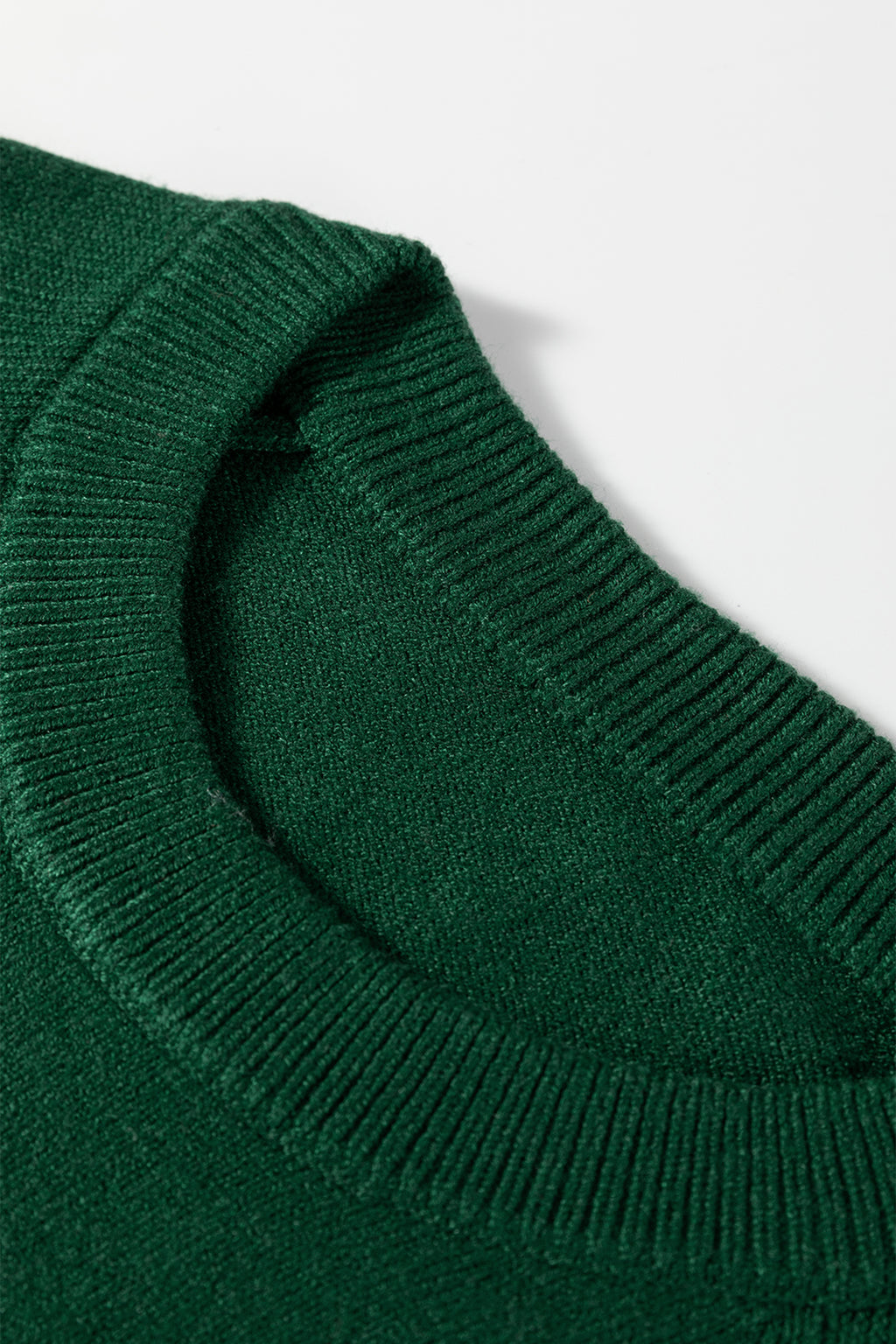 Close-up of a green sweater collar, ideal for pairing with a white MERRY Christmas sweater