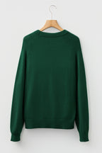 Back view of a green sweater with a cozy fit, ideal for pairing with a white MERRY Christmas sweater
