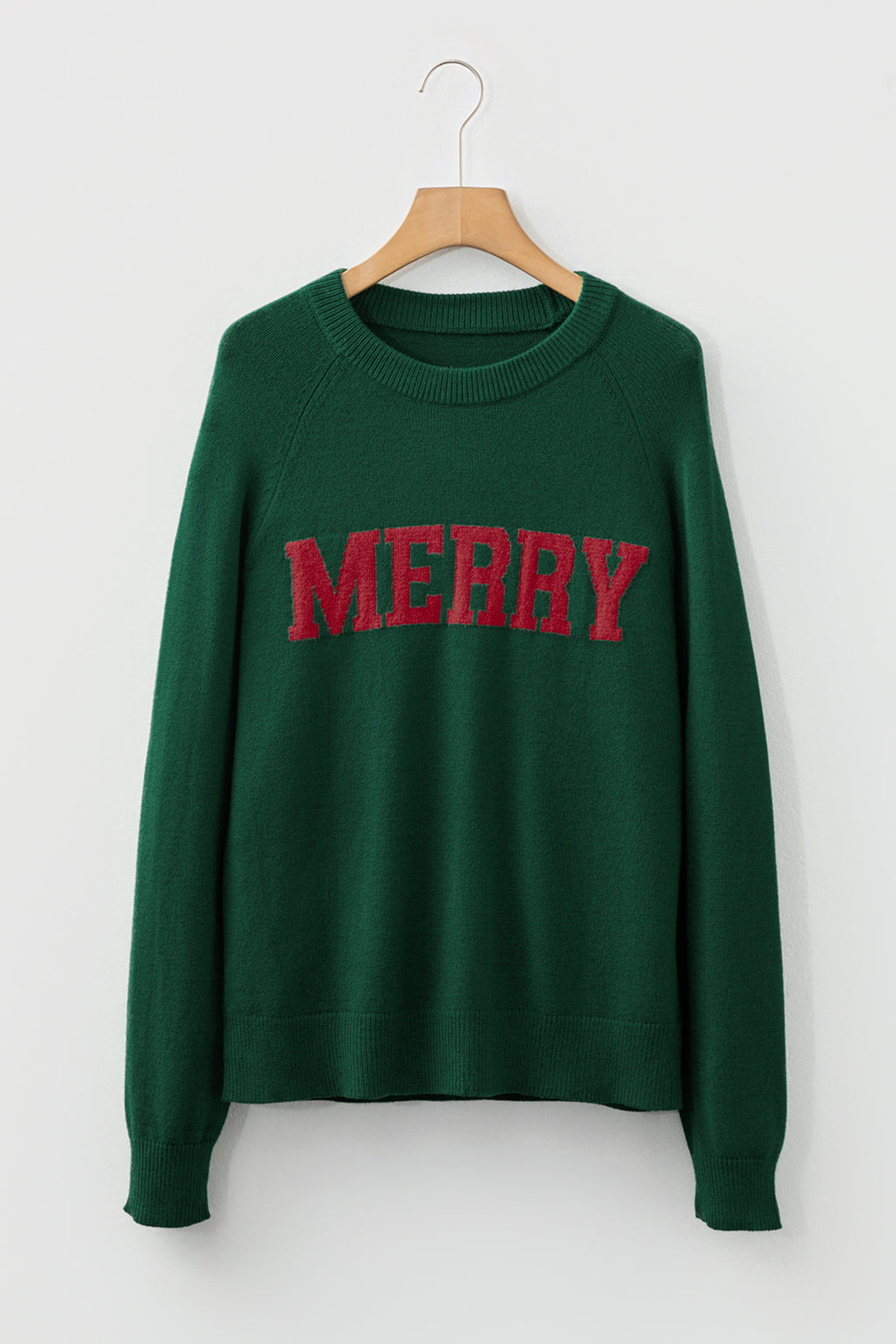Green sweater with red MERRY Christmas sweater graphic for festive holiday style