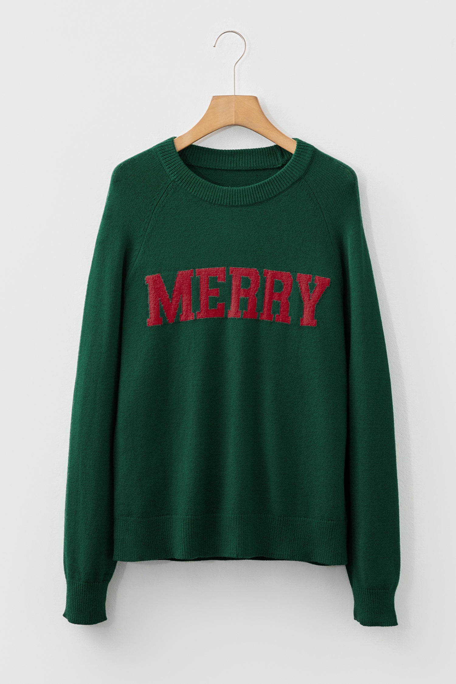 Green sweater with red MERRY Christmas sweater graphic for festive holiday style