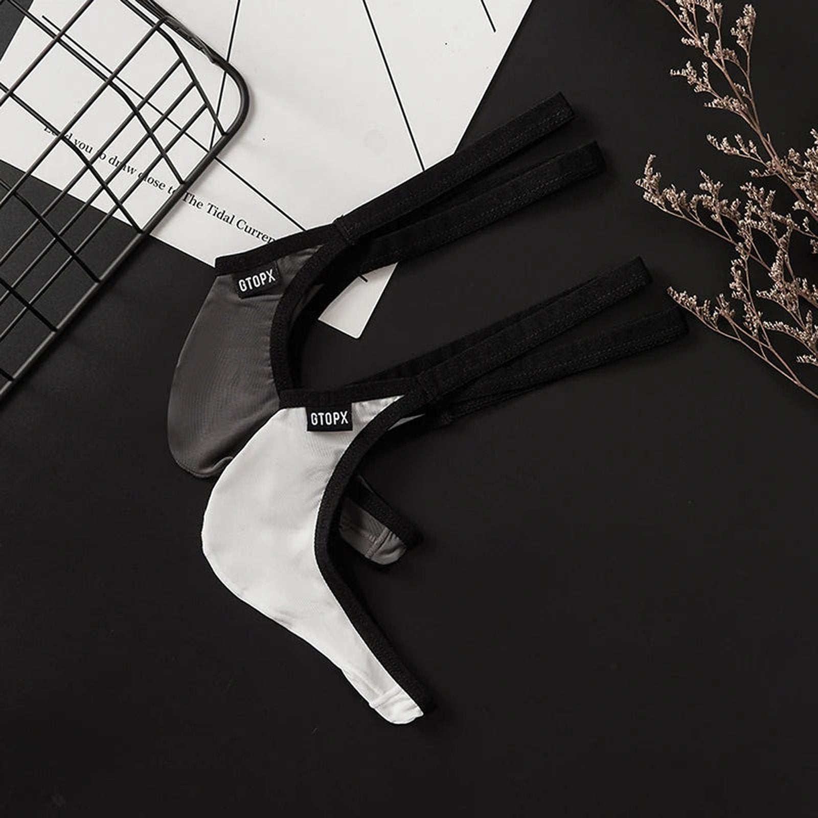 Men's ultra thin thong underwear in black and white with soft elastic straps for all-day comfort