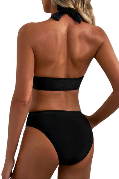 Back view of a woman wearing a black halter v neck push up bikini by LuckeLadybug LLC