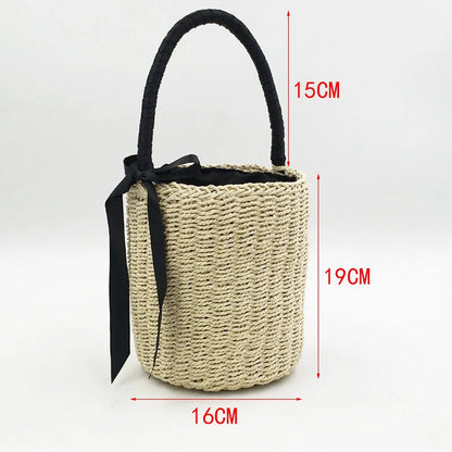 Handmade straw beach bag for women with black handle and ribbon, perfect for summer outings