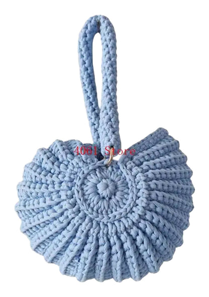 Handwoven seashell clutch bag in light blue with a unique design and sturdy handle