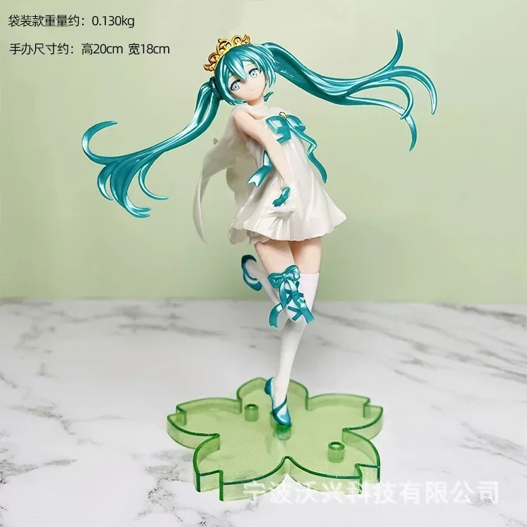 Hatsune and Miku figurine in a white dress with blue accents, standing on a clear green base, 20cm tall