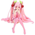 Hatsune and Miku figurine featuring vibrant pink hair and cherry accessories, perfect for collectors