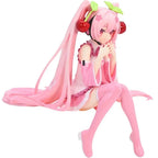Hatsune and Miku collectible figurine with pink hair and cherry-themed accessories
