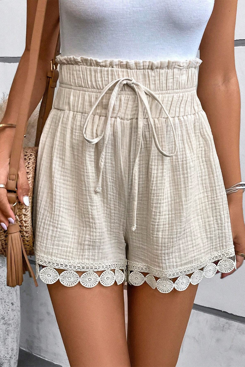 Beige high-waist shorts from LuckeLAdybug LLC with scalloped hem and drawstring waist detail