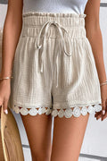 Light beige high-waist shorts with a drawstring and lace trim, perfect for summer outfits