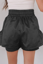 Black high-waist shorts with elastic waistband and side pockets for a comfortable fit