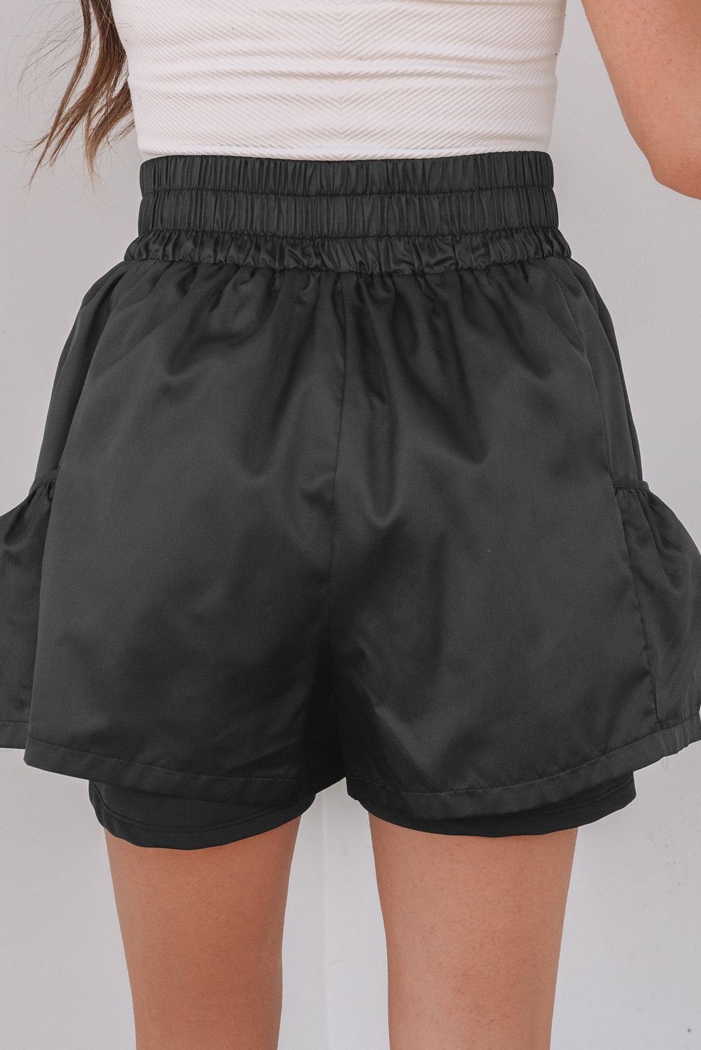 Black high-waist shorts with elastic waistband and side pockets for a comfortable fit