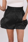 Black high-waist shorts with elastic waistband and side pockets for a stylish look