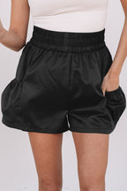 Black high-waist shorts with elastic waistband and side pockets for a stylish look