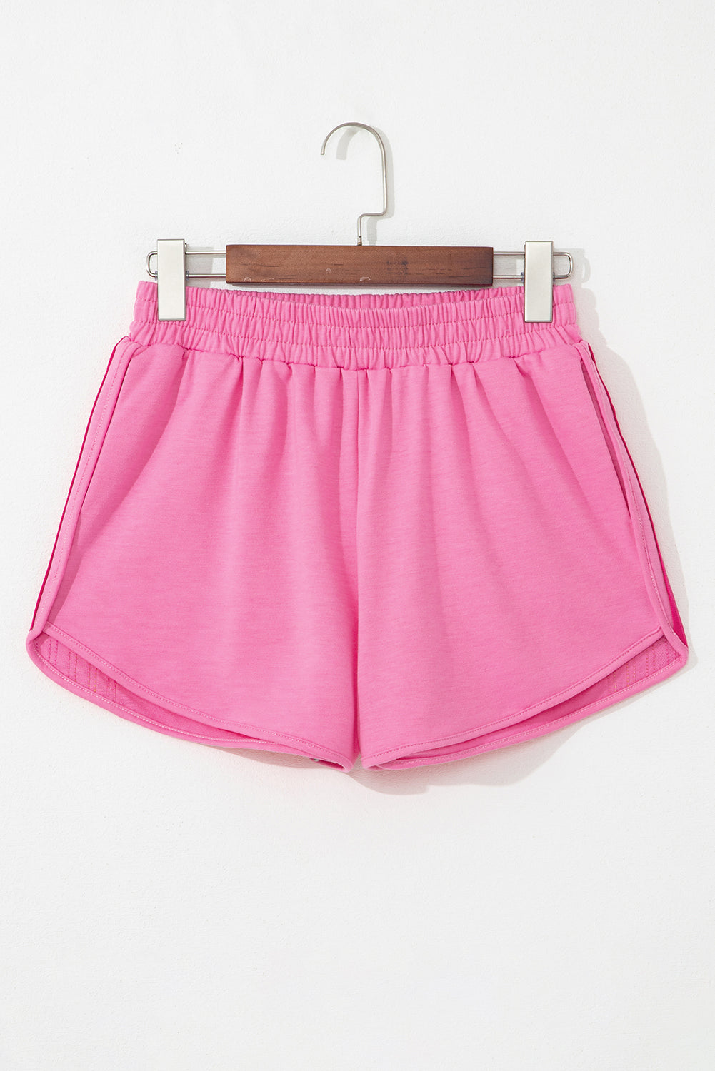 Bright pink high-waist shorts with an elastic waistband for comfortable all-day wear