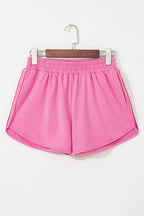 Bright pink high-waist shorts with an elastic waistband for comfortable all-day wear