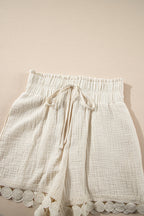 Lightweight cream high-waist shorts with a drawstring and lace trim for summer comfort