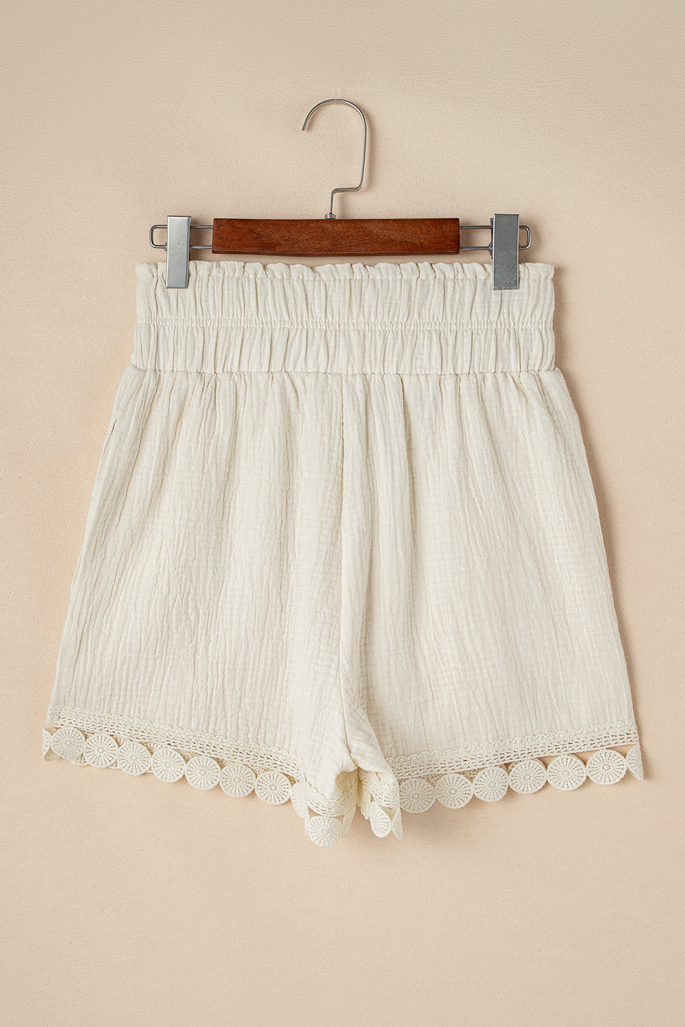 Cream high-waist shorts with lace trim and smocked waistband for comfortable summer wear