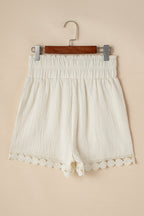 Cream high-waist shorts with lace trim and smocked waistband for comfortable summer wear