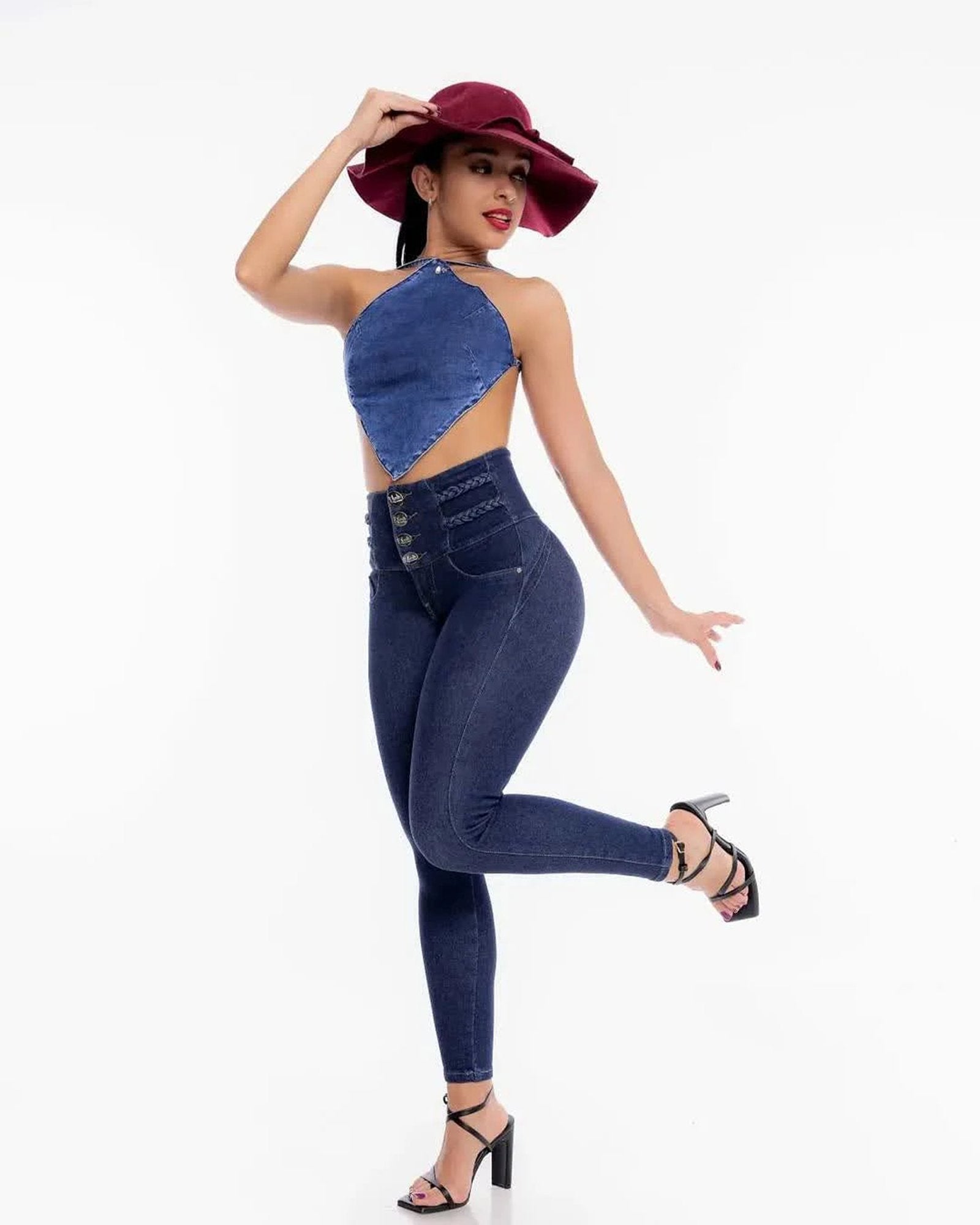 Stylish high waisted skinny jeans for women in dark wash with trendy cutout top and hat