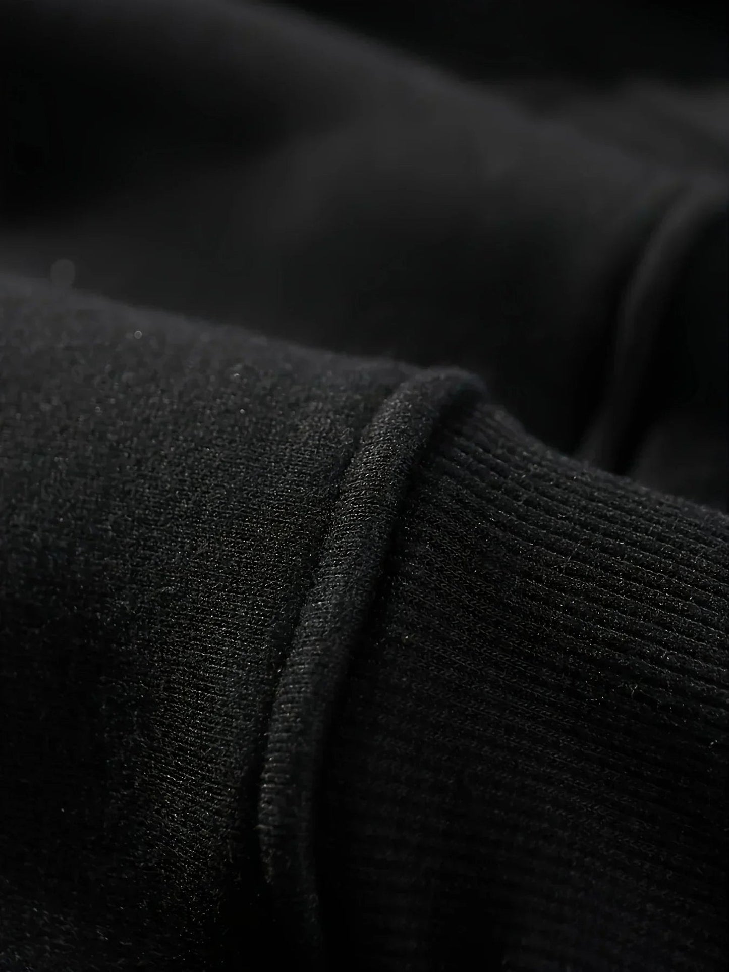 Close-up of a black hockey mom hoodie showcasing soft fabric and ribbed cuffs