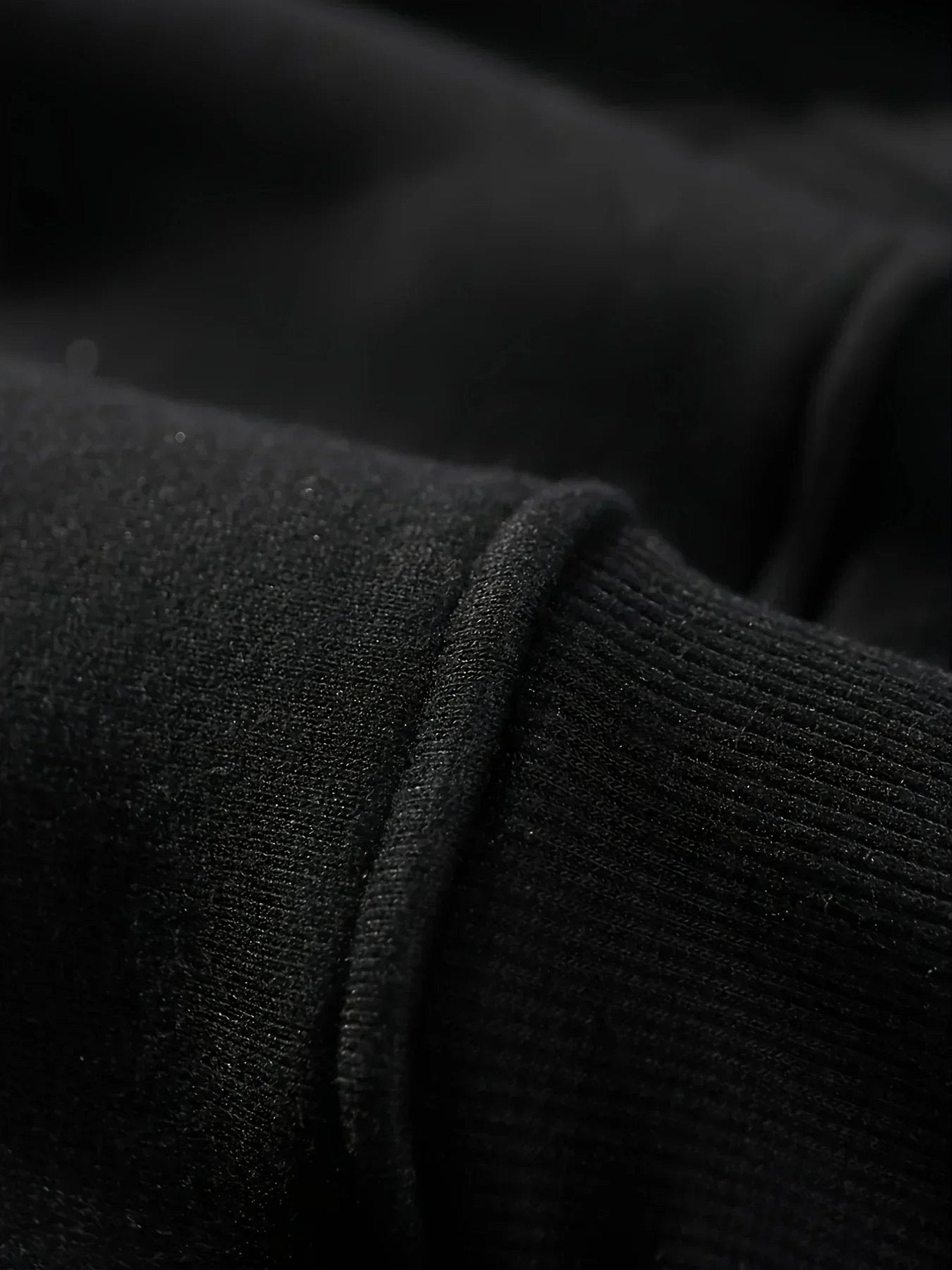Close-up of a black hockey mom hoodie showcasing soft fabric and ribbed cuffs
