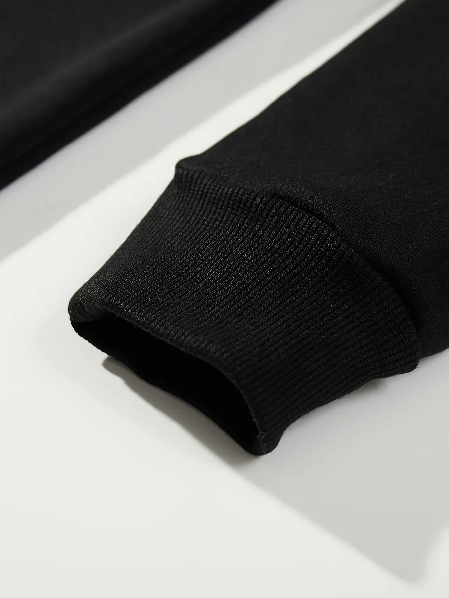 Close-up of black hockey mom hoodie sleeve showcasing ribbed cuffs by LuckeLadybug LLC