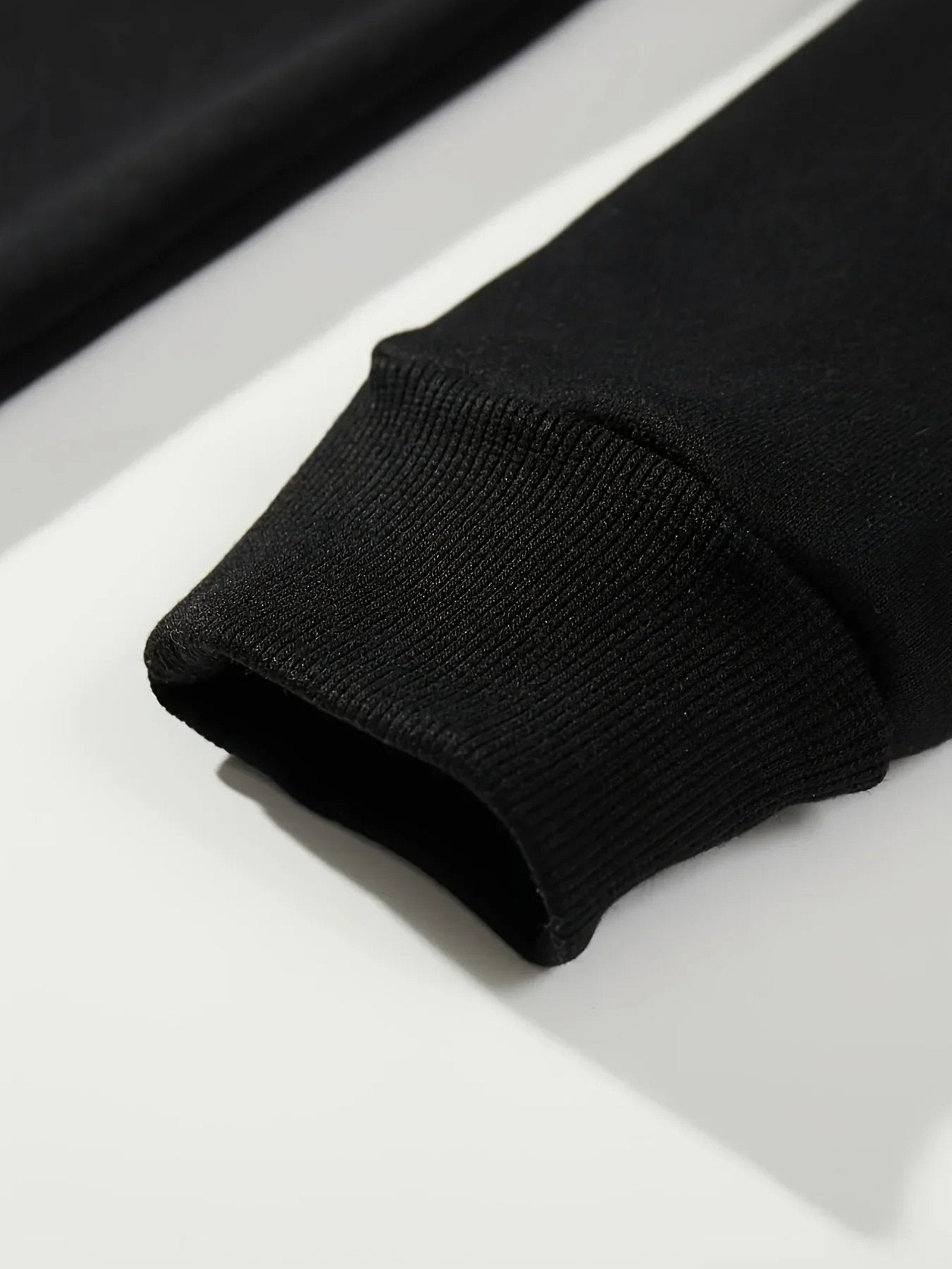 Close-up of black hockey mom hoodie sleeve showcasing ribbed cuffs by LuckeLadybug LLC