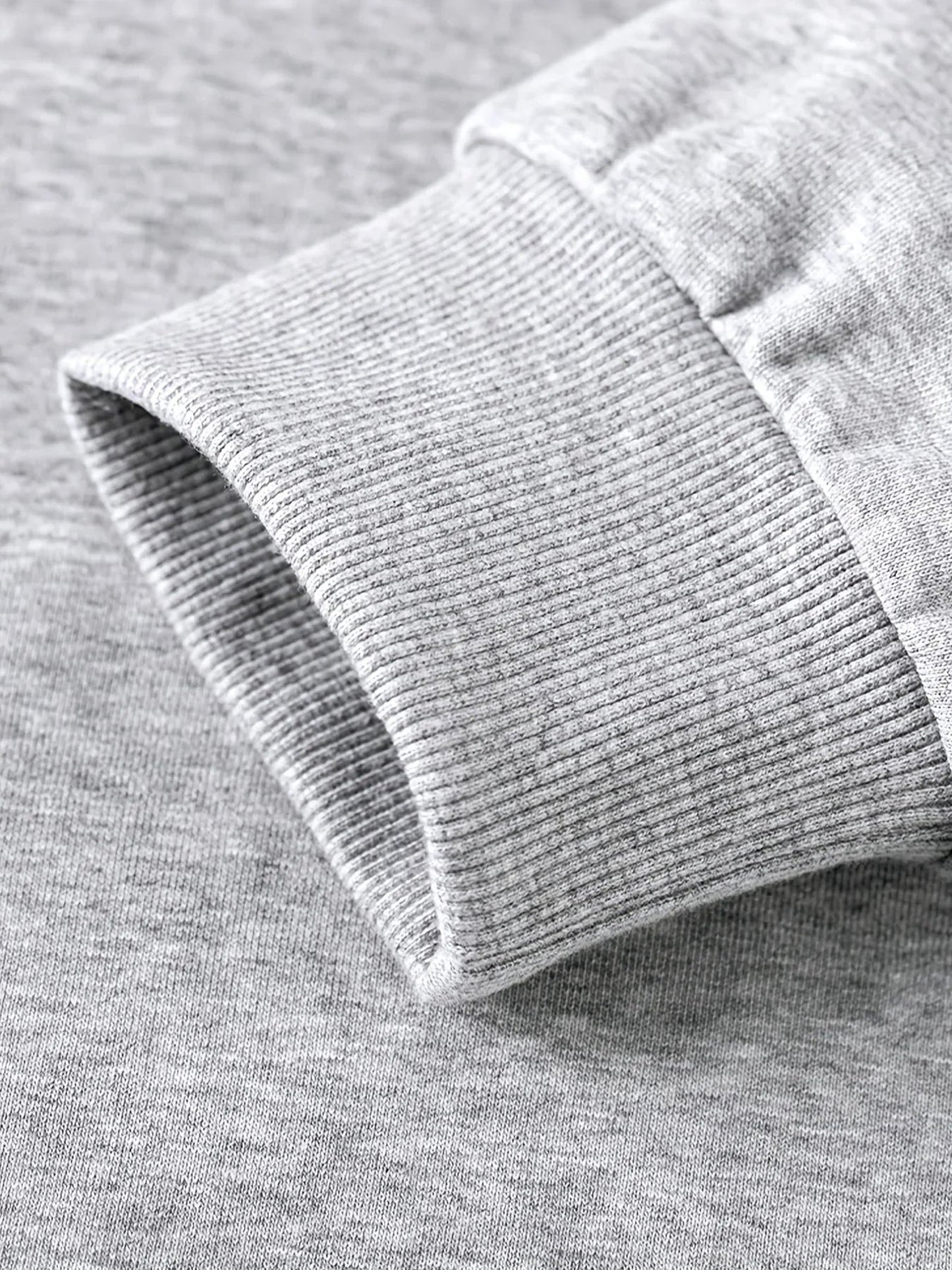 Close-up of a gray hockey mom hoodie showcasing the soft ribbed cuff design