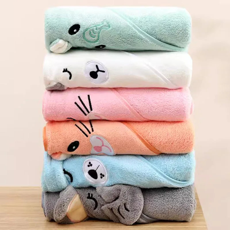 Stack of colorful hooded newborn towels featuring cute animal designs for bath time comfort