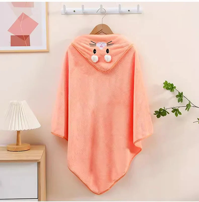 Cute hooded newborn towel in peach color featuring animal ears and pompom accents for baby bath time